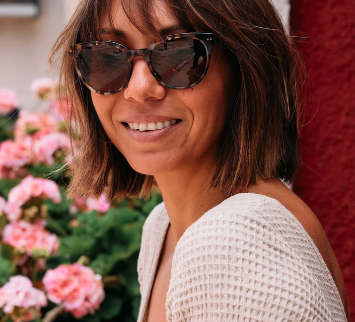 A woman wearing Otis & Piper sunglasses